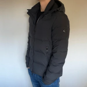 J Lindeberg jacka - Säljer nu min pufferjacket från j lindeberg i storlek M | den är perfekt nu till hösten/Vintern och är riktigt varm o skön, högra fickans sömm har gått upp men inget man ser när den är stängd och fickan fungerar som vanligt, därför detta billiga pris.