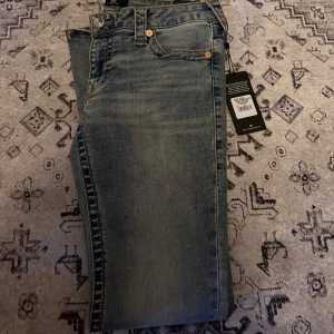 True Religion flared jeans blå low rise - Säljer dessa True Religion-byxor då de tyvärr är för stora för mig. Byxorna är helt nya och aldrig använda 🤍 Öppen för prisdiskussion, och vill du se fler bilder är det bara att höra av dig! ✨ Nypris ligger runt 1,4