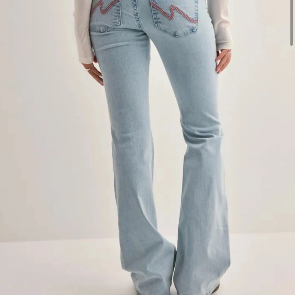 Bootcut ljusblå jeans med slitningar