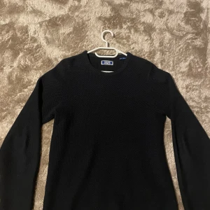 Svart stickad tröja Jack & Jones - Svart stickad tröja från Jack & Jones med rund hals och långärmad passform. Det är en liten tjockare tröja än vanligt men är perfekt nu till vintern. 