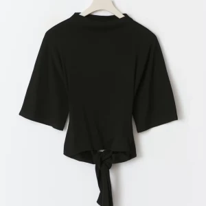 Svart croppad topp med knyt - Säljer en svart croppad topp med breda, korta ärmar och snygg knytning i ryggen. Toppen har öppen rygg och är tillverkad i ett mjukt, slätt material. 