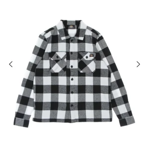 Svartvit rutig skjorta från Dickies - Säljer en svartvit rutig skjorta från Dickies med klassisk krage, två bröstfickor med lock och knappar framtill. Skjortan har lång ärm och är tillverkad i mjuk bomull. Perfekt för dig som gillar streetwear och avslappnad stil.