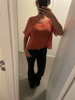 croppad blus - Säljer en luftig och croppad blus i en varm, härlig färg. Toppen har en lös passform, korta ärmar och bred rund halsringning som kan bäras offshoulder. Materialet känns lätt och flowy, perfekt för varmare dagar. Strl L men passar även mindre strlk se bild. Färgen är terrakotta enligt mig men fanns inte att välja som alternativ. Se därför bild för uppfattning om färg.