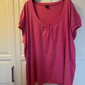 Rosa topp från Cellbes i bomull strl 62/64 - En oversized rosa topp från Cellbes med rund halsringning och korta ärmar. Tillverkad i mjuk bomull. Storlek 62/64. Kan hämtas i Vallentuna.