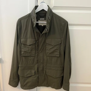 Grön Field Jacka - Sjukt snygg Field Jacka från East West, jackan är i ett väldigt bra skick utan deffekter. Storlek S. 