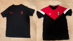 AC Milan fotbollströjor från Puma - Två AC Milan fotbollströjor från Puma. Ena är helsvart med rött Puma-logga och klubbmärke, andra har röd och svart design med vita detaljer, V-ringad hals och tryckta loggor. Perfekt för dig som vill visa support för Milan på match eller träning.