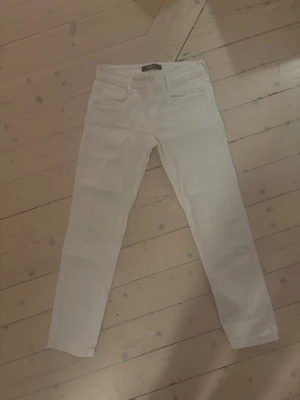 Vita Replay jeans slim fit - OVANLIGA** snygga vita jeans från Replay med klassisk femficksdesign och slim fit. Byxorna har en rak siluett och är tillverkade i mjukt jeanstyg med stretch för extra komfort. Perfekta för dig som gillar stilrena och fräscha looks.