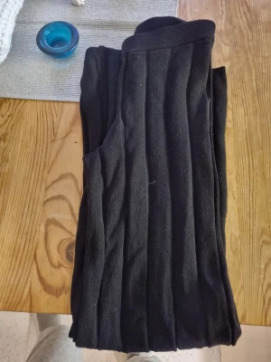 Svarta ribbade leggings - Säljer ett par svarta ribbade leggings med hög midja. De är stretchiga och mjuka, perfekta för en chill och snygg look. Passar till både oversized tröjor och crop tops.