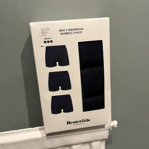 Mörkblå bambushorts från Resteröds - Säljer ett 3-pack mörkblå boxershorts/kalsonger från Resteröds i mjuk bambu- och bomullsblandning. Klassisk passform med medellångt ben och diskret logga i midjan. Perfekta för dig som vill ha bekväma och stilrena underkläder. Aldrig öppnat paketet!