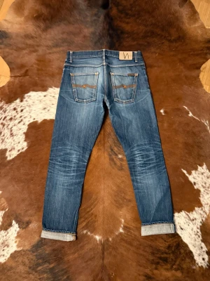 Selvage Nudie GrimTim - Tjena! Säljer dessa riktigt feta Selvage Nudie GrimTim, jeansen är i fint skick och har knappt några lagningar, W33/L34 hör av dig vid funderingar!🙌
