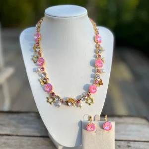 Smyckesset Rose halsband örhängen  - Ett set med halsband och örhängen med brisyrkrok i guldplätterad mässing och kristaller. Färg Powder Rose De Lite Rivoli 14mm. Light Rose och Rose ss29 och Rosaline ss39. Längd 51cm inkl lås. Charms i mässing pärlor. Finns även att få i andra färger på kristallen. Sista bilderna visar andra varianter.  Jag skickar endast spårbart, samfraktar. Fast pris. Besök gärna mina övriga annonser.  Till mina smycken använder jag kristaller från Preciosa, Aurora och Swarowski.