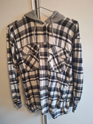 Rutig hoodie från H&M med huva - Säljer en svartvit rutig hoodie från H&M i storlek 36. I bra skick 