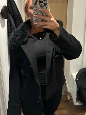Svart neo noir pälskappa  - Snygg och lyxig svart pälskappa med fluffig krage från neo noir, perfekt till både höst och vinter! Köpt för 2000kr.