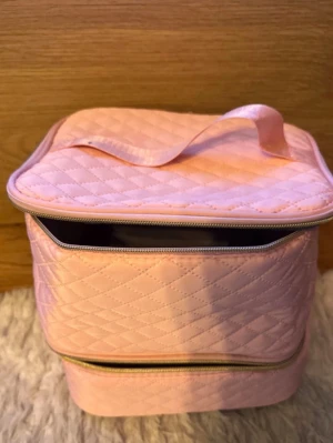 Rosa nagelförvaringsväska  - Snygg quiltad rosa förvaringsväska med dragkedja och handtag, perfekt för att organisera nagellack, penslar och andra nagelprodukter. Väskan har flera fack och elastiska band för att hålla allt på plats. Passar dig som gillar ordning bland nagelgrejerna. Allt ni ser på bilden medföljer. 