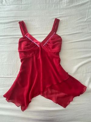 Röd asymmetrisk linnetopp med paljetter - Röd asymmetrisk linnetopp med paljetter