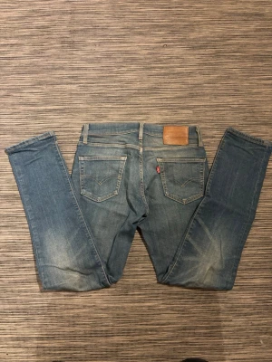 Blå Levis jeans med raka ben - Säljer ett par snygga jeans från Levi’s! Jeansen är i mycket bra skick och har inga defekter. Storlek 28/32. Om ni har några frågor så är de bara att höra av er!😊