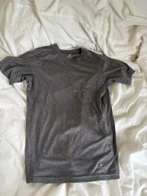 Mörkgrå tränings t-shirt  - En enkel träningströja som är väldigt bekväm. Bra kvalitet men behöver säljas för att jag har för mycket träningskläder. 