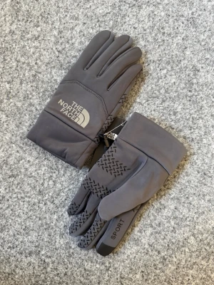 The North Face gray sports gloves - Thick and atheltic. One size fits all. Brand new