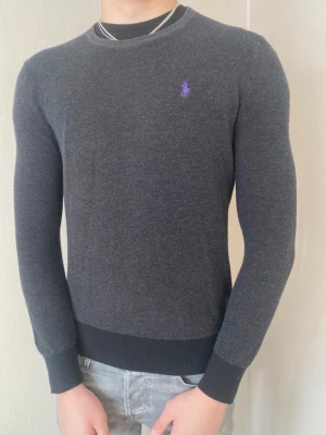 Mörkgrå tröja från Ralph Lauren - Snygg mörkgrå tröja från Ralph Lauren med cool och unik lila logga på bröstet. Passar till allt o funkar året om! Postar inom 24h📦 Köp mer än ett plagg för 10% rabatt!🤝 Tveka inte på att höra av er vid frågor eller funderingar!
