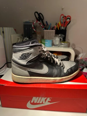 Air Jordan 1 Shadow (2018) - EU 43 - OG Classic - Air Jordan 1 Retro High OG “Shadow” 2018.  Timeless OG colorway. Black/grey premium leather. Works with everything — minimal fits, baggy Y2K, straight denim, cargos.  Size: EU 43 (US 9.5) 100% authentic Style code: 555088-013  Condition: Worn with visible creasing and normal signs of use. No holes or structural damage. Still solid and very wearable with plenty of life left. 