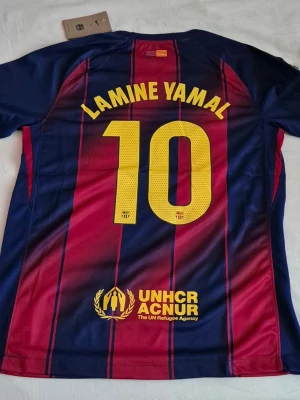 FC Barcelona Home Jersey 25/26 Lamine Yamal #10 Nike Football Shirt - Size: M Condition: New (Never worn) Color: Barcelona Home Colors (Blue & Garnet) Material: Nike Dri-FIT / Polyester  Dimensions (Estimated) Armpit Width ≈ 54cm Length ≈ 72cm  Ships within 24 hours  Any questions? Feel free to ask!