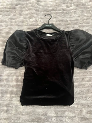 Klänning svart med puffärm - Svart långklänning i mjuk material med stora puffärmar i transparent tyg, Använd en hel del men ändå fint skick.