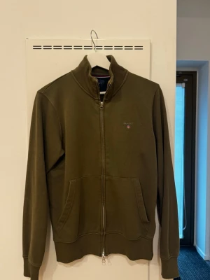 Olivgrön zip hoodie från Gant - *HERR*  Grön tröja från Gant.   Storlek S.   Bra skick inget att anmärka