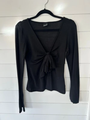 Gina långärmad topp  - Svart topp med knyt i mitten