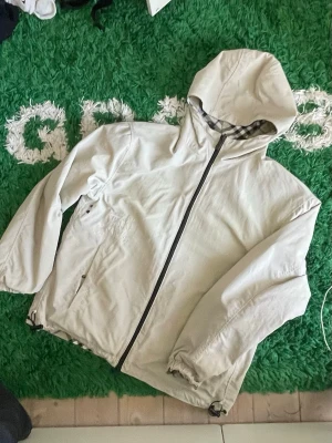 Double sided Burberry windbreaker  - ⚜️Double sided Burberry windbreaker ⚜️               Very nice windbreaker I got as a gift, but don’t see myself using.                                                           Its hard too see but on the left side of the jacket there’s a Burberry logo, followed by of course It’s double sided, which means you can flip it inside out so you can see the Burberry print.                      All new with tags. Size S but can also fit some M.                                   The price is not fixed