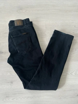 Nudie 31/34 - Ett par riktigt feta Nudie 31/34. Passformen e dunder, den heter något med Jackson tror jag. Byxorna har sina slitningar vid byxändarna men är annars i gott skick. Skriv vid frågor och kolla gärna in min profil för fler feta jeans, bälten och tröjor. Vid köp av fler saker kan jag lösa paketpris o rabatt:)