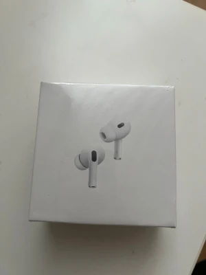 Apple AirPods Pro 2nd gen vita - Säljer ett par Apple AirPods Pro (2nd generation) i vitt. Trådlösa in-ear hörlurar med stilren design och silikonproppar för bra passform. Kommer i originalförpackning. Perfekta för musik, samtal och träning.