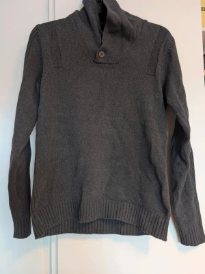 Mörkgrå stickad tröja med krage - Säljer en mörkgrå stickad pullover tröja i otroligt fint skick. I storleken S men skulle säga att den passar XS också.