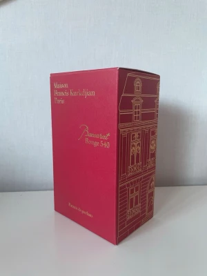 Baccarat Rouge 540 Extrait de Parfum - Lyxig parfym från Maison Francis Kurkdjian, Baccarat Rouge 540 Extrait de Parfum. Flaskan är djup röd med guldfärgat lock och etikett. Kommer i elegant röd kartong med gulddetaljer och medföljande booklet. En ikonisk doft med exklusiv känsla.
