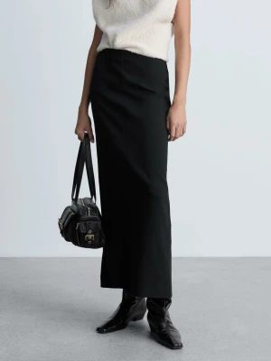 Svart långkjol med slits från MANGO storlek 36 - Stilren svart långkjol med rak passform och diskret slits bak. Kjolen har minimalistisk design och är perfekt att matcha med boots eller sneakers. Från Mango i storlek 36, normal i storlek. Ny med prislapp