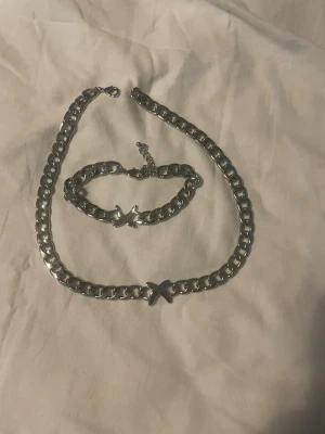 Kedjehalsband och armband med fjäril - Säljer ett lite tjockare matchande armband och halsband. Lite längre och större i storlek, går att ändra. Köpte för 550 och säljer för 200
