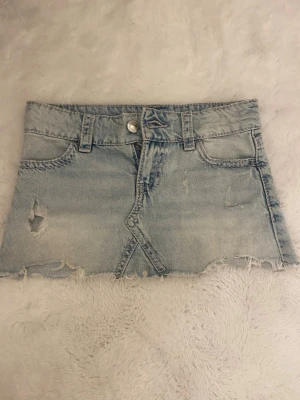 Ljusblå jeanskjol med slitningar - Snygg jeanskjol 