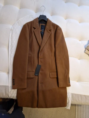 Oanvänd herr kappa/Rock - Helt ny i storlek XS. Stilren och tidlös kappa. Sista pris 500 kr. Inga byten eller returer. Skickar spårbart och försäkrat mot porto. 