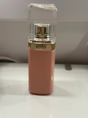 BOSS parfym rosa flaska - parfym från Hugo Boss i en rektangulär, rosa flaska med gulddetaljer och genomskinligt lock. Fick begagnad av mammas vän, den var inte min smak! Pris kan diskuteras 