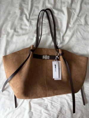 Brun axelväska  - Helt ny populär brun axelväska från Gina tricot 🤍 stor med mycket plats för tex dator, böcker mm!! 