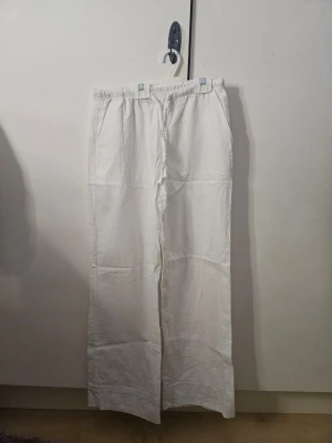 Vita linnebyxor från gina tricot - Snygga vita linnebyxor från Gina Tricot med låg midja och raka ben. Perfekta för sommardagar. Väldigt genomskinliga, sitter snyggt, endast använda få gånger och i bra skick. Tyvärr så är storlekslappen avklippen men original storlek är xs, men de är uppsydda längst ner så att de passar storlek 152! Perfekta för sommaren. Nypris runt 300 kr! OBS. de har en liten fläck på ena benet (se sista bild)