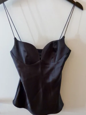 Zara topp - Svart satin topp från Zara med smala band och en dragkedja på sidan. Knappt använd