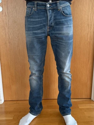 Blå slim fit jeans från Nudie Jeans - Säljer mina helt nya utan prislapp nudie jeans i modellen grim Tim storlek 31/32. Superfina jeans passar till vardagslooken och har en snygg passform. Nypris är ca 1600. Snygg blå färg passar till allt! Perfekt nu inför våren/sommaren!