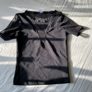 Svart topp - Svart topp från H&M med mesh-tyg högst upp. Endast använd ett fåtal gånger så den är i mycket fint skick! 💕