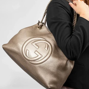 Gucci Soho Chain Bag - GUCCI Soho Chain Bag är i Gold Metallic läder. Väskan är i väldigt gott skick och är knappt använd. Det är den perfekta väska med bra storlek för extra tillhörigheter. Väskan har en lång guld kedja som du man bära som singel kedja som en cross bag väska eller med dubbel kedja över axeln. Väskan fungerar till vardag och fest. Väskan är köpt på Gucci butiken i Stockholm. Kvitto och dustbag medföljer! Hör av er för fler bilder ☺️