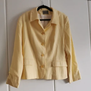 Gul kavaj med axelvaddar  - Kavaj med axelvaddar från Zavanna i fin ljusgul färg. 