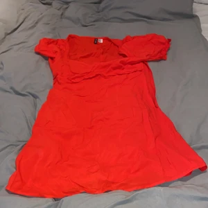 Röd klänning med puffärm. - Det står storlek 44 men passar som en 38/40. Köparen står för frakten.