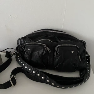 Nunoo väska  - Säljer den här fina Nunoo väskan som ej kommer till användning! De svarta långa väskbandet går att ta av och använda till andra väskor! Köpt på boozt för 1499kr. Priset går att diskutera! Köparen står för frakten! 