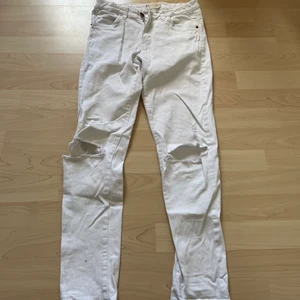 Vita jeans - Vita jeans med hål på knäna. Storlek 170 låga i midjan med resårband i midjan. Tvättas innan skickas.  Köparen betalar frakt och bestämmer om det ska vara fraktbart. Priset är prutbart 