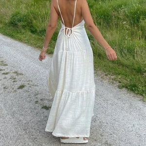 Vit sommarklänning 🐚💐💕 - En vacker långklänning perfekt till sommardagar, kanske till midsommar? Den är i storlek M men passar S då den går att spänna i ryggen. Köpt från Bik Bok sommaren 2021 men endast använd en gång. Klänningen finns inte kvar i deras sortiment 💕