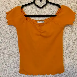 Fin offshoulder-tröja med fina sömdetaljer. Svårt att få rätt färg på bild men tröjan är mycket finare och klarare orange i verkligheten. Storlek XL men känns mer som en M eller L. 